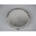 A George III silver shaped circular Waiter engraved bird crest, beaded rim on ball and claw feet,