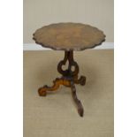 A 19th Century Continental walnut Occasional Table with shaped circular top on three shaped supports