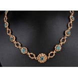 A Blue Zircon Necklace claw-set thirteen round stones in ropetwist frames with knot effect links