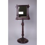 A Georgian mahogany Shaving Mirror with rectangular plate on adjustable turned column with