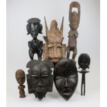 A group of decorative African Tribal Carvings, including a Dan mask, three Akan dolls, two Senufo