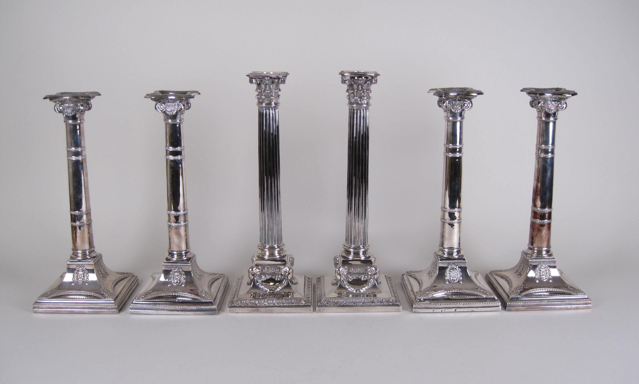 A set of four Walker and Hall corinthian column silver plated Candlesticks on stepped square bases