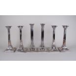 A set of four Walker and Hall corinthian column silver plated Candlesticks on stepped square bases