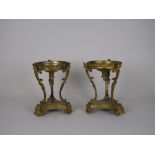 A pair of ormolu Table Stands, circular with three shaped supports surmounted with busts, the