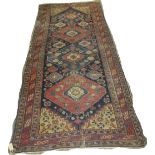 A Northwest Persia Runner, early 20th Century, signed, 10ft x 4ft 5in (worn, tears) Provenance: