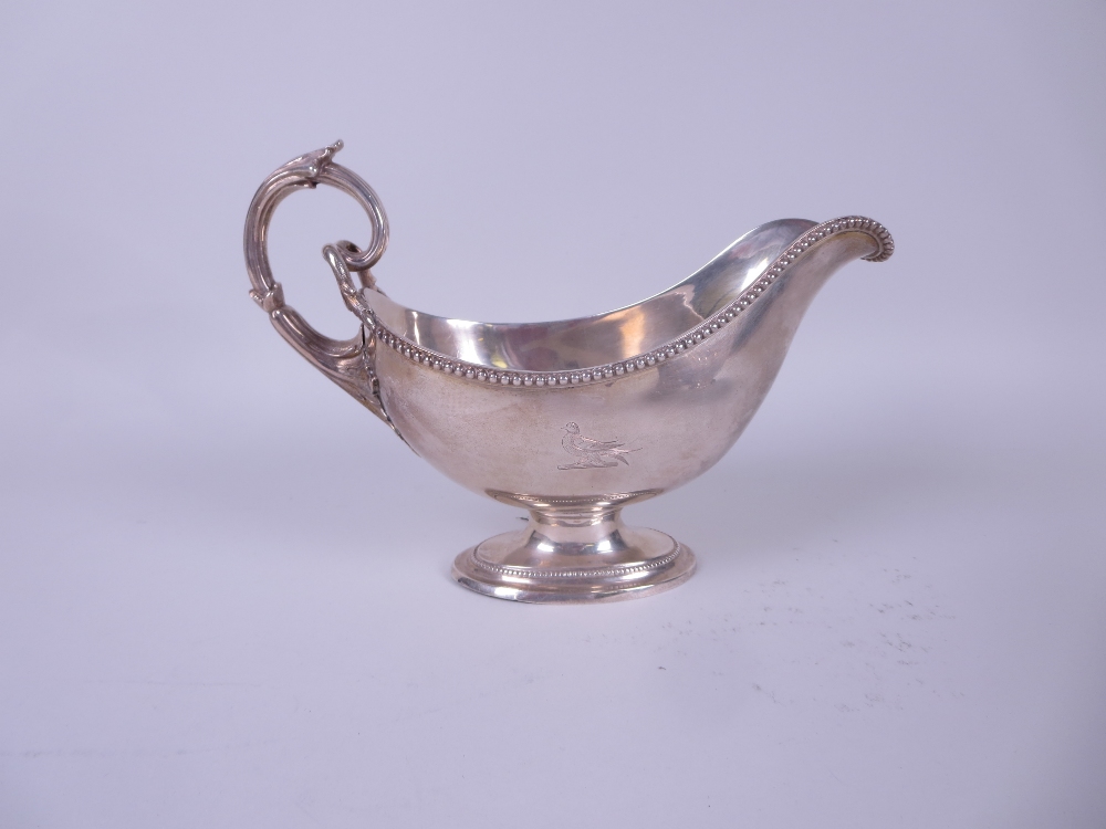 A Victorian silver large Sauce Boat engraved bird crest and monogram, beaded rim, leafage scroll