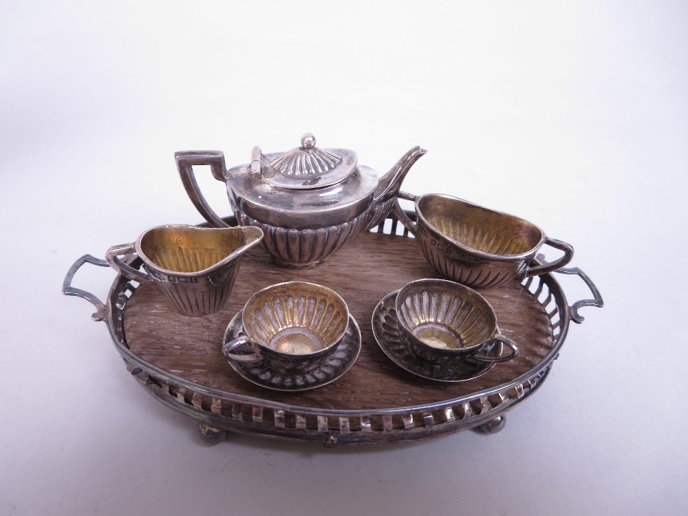 An Edward VII/George V silver miniature Tea Service, viz: Teapot, Sugar Bowl, Jug, two Cups and