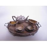 An Edward VII/George V silver miniature Tea Service, viz: Teapot, Sugar Bowl, Jug, two Cups and