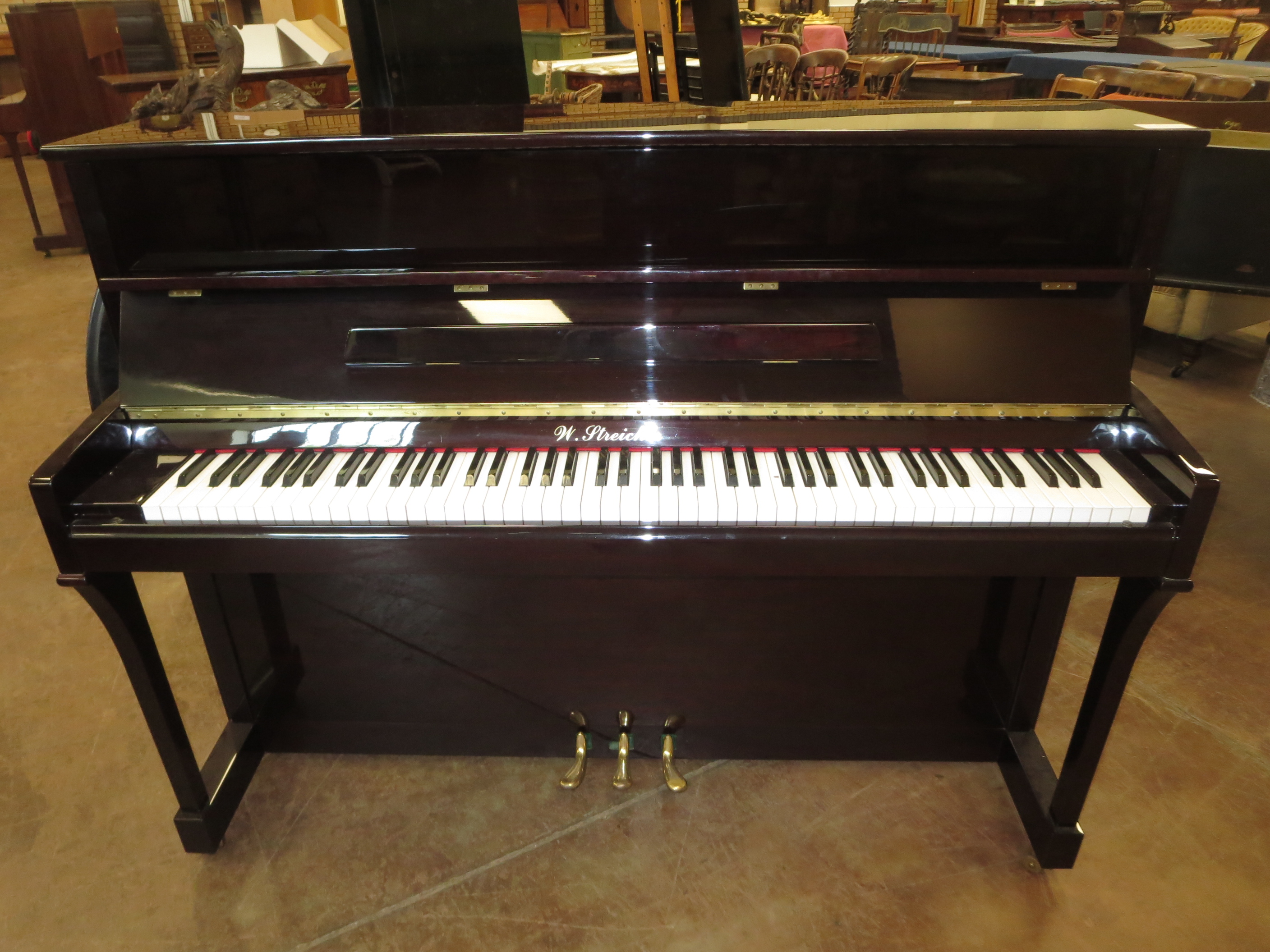 A good quality modern upright Piano by W Streicher, 7 1/4 octaves, iron frame, overstrung, in highly