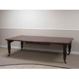 A 19th century mahogany Extending Dining Table on fluted tapering supports and brass casters,