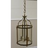 A 19th Century circular Hall Lantern, the moulded brass frame with C scroll swept supports above a