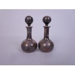 A pair of Art Nouveau small silver overlaid Scent Bottles and Stoppers of club shape with dolphin