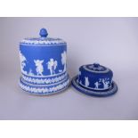 A Wedgwood bue jasperware Cheese Dome and Stand with friezes of classical figures and leafage,