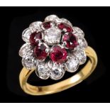 A Diamond and Ruby Flower Cluster Ring claw-set brilliant-cut diamond within frame of six round