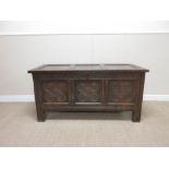 A 17th Century oak Coffer with panelled top, roundel carved frieze above carved panels, 4ft 2in W