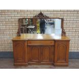 A Victorian oak Sideboard with raised mirror back having scallop and scroll carved surmount, the