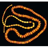 An Amber Bead Necklace, approx 165gms, and a graduated Amber Bead Necklace, approx 27gms