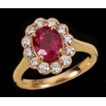 A Ruby and Diamond Cluster Ring claw-set oval-cut ruby, 1.25cts, within a frame of brilliant-cut