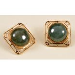 A pair of Jade Earrings each set round cabochon within open work gold frame