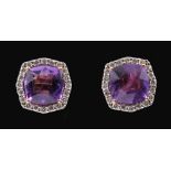 A pair of Amethyst and Diamond Cluster Earrings each claw-set cushion-cut amethyst within frame of
