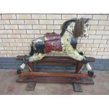 A Victorian painted Rocking Horse on wooden stand, 3ft 6in L, seat A/F