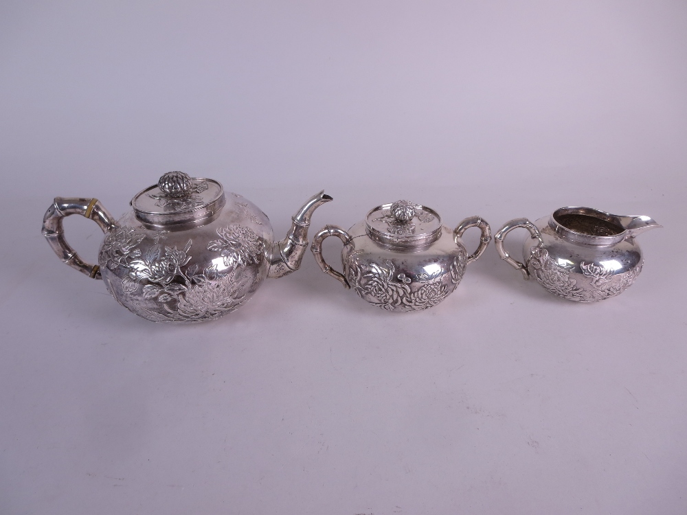 A Chinese silver three piece Tea Service decorated insects and chrysanthemum, the teapot and sucrier - Image 2 of 10