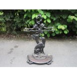 A cast iron Stick Stand with naturalistic design of a dog sat beside a leafy tree with