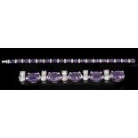 An Amethyst and Diamond Line Bracelet claw-set eighteen oval-cut amethysts, total amethyst weight