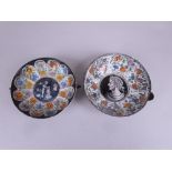 Two Limoges enamel Saucer Dishes decorated 'Ceasar' and cherub with barrel, tulip surround and