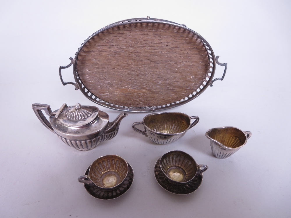 An Edward VII/George V silver miniature Tea Service, viz: Teapot, Sugar Bowl, Jug, two Cups and - Image 2 of 3