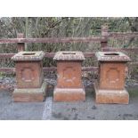 A set of three terracotta Pedestals with egg and dart borders and plinth bases, 2ft 5in H