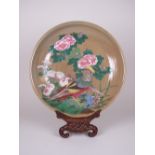 A Japanese earthenware Charger decorated exotic birds and flowers in famille rose colours, 14 1/2 in