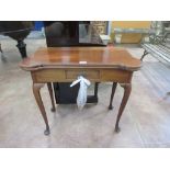 An 18th Century mahogany Tea Table with shaped rectangular fold-over top on cabriole legs and pad