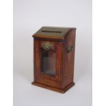 An oak and brass Letter Collection Box with brass fittings and hinged and glazed pull-out front,