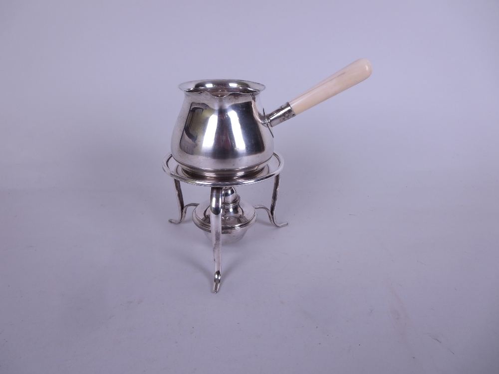 An Edward VII silver Brandy Saucepan with turned ivory handle, Sheffield 1907, on plated Stand