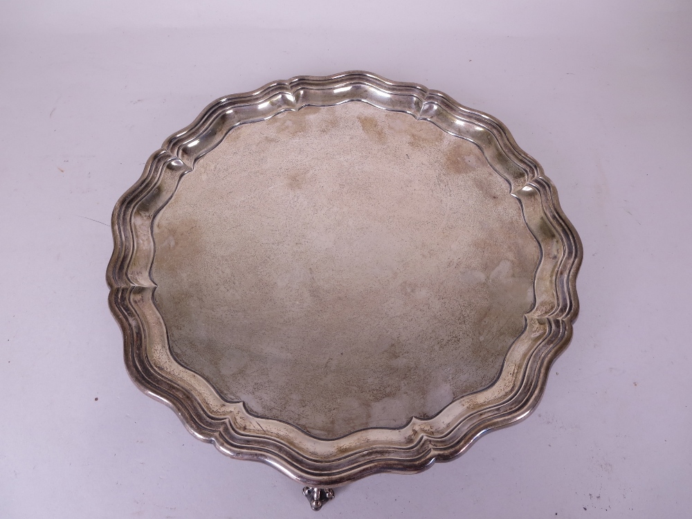 An Edward VII silver shaped circular Salver on four ball and claw feet, Sheffield 1903, 12 in D, and