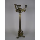 A large Regency brass/bronze Candelabrum, the outer sconces supported on winged mythical figures,