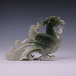 A Chinese celadon hardstone Carving of a Phoenix (fenghuang), with long tail, folded wings, horns