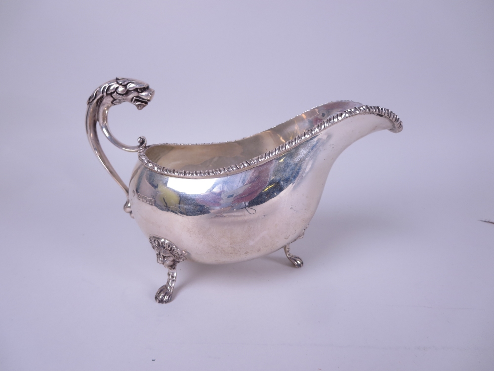 A George V silver Sauce Boat with gadroon rim, mask and leafage scroll handle on lion mask and paw - Image 2 of 2