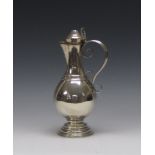 A Victorian silver Ewer of baluster form with fleur de lys engraved spout and collar on spreading