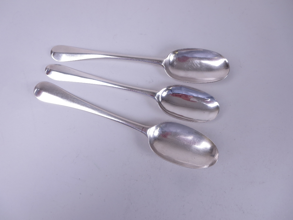 Two George I silver Table Spoons, hanovarian pattern with rat tail bowls, one with initials M.H.,