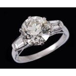 A Diamond single stone Ring claw-set old-cut stone, approx 3.00cts, between two baguettes, ring size