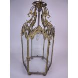 A gilt-metal hexagonal gothic style Hall Lantern with floral and scroll design, plain glass