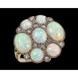 An unusual Opal and Diamond Cluster Ring set seven opal cabochons interspersed with twelve rose-