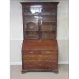 A George III mahogany Bureau Bookcase with dentil cornice and an inlaid frieze, a pair of astragal