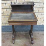 A Regency rosewood Davenport with raised back having spindle gallery, fitted drwers to the interior,