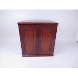 A late 19th/early 20th Century mahogany Coin Cabinet with two door front, fitted with twenety one