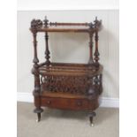 A Victorian walnut Canterbury Whatnot with carved pierced panels, turned supports and fitted