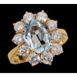 An Aquamarine and Diamond Cluster Ring claw-set oval-cut aquamarine, 2.51cts, within a frame of