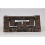 A Zulu Headrest, South Africa, the bowed platform above chip carved and pokerwork block support,